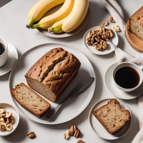 A close-up of a slice of banana bread topped with melting butter, highlighting the rich, moist crumb and visible banana pieces, with a fork beside it (2)