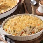 Mamaw's Chicken and Rice Casserole served in a baking dish with a wooden spoon, creamy and golden brown (2)